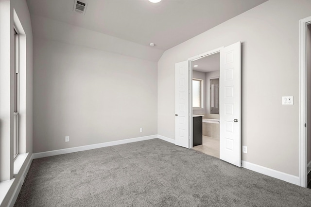 unfurnished bedroom with lofted ceiling and light colored carpet