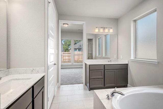 bathroom with vanity, tile patterned floors, and a bathtub