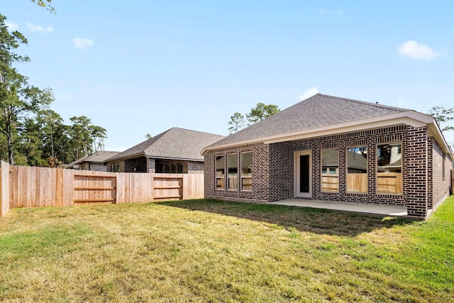 back of house featuring a yard and a patio