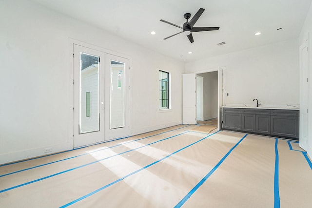 unfurnished bedroom with ceiling fan and sink