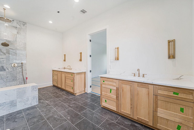 bathroom with a tile shower and vanity