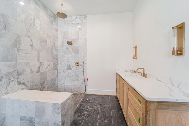 bathroom with vanity and a tile shower