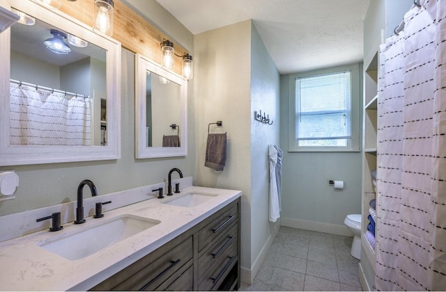 bathroom with tile patterned flooring, vanity, a shower with curtain, and toilet