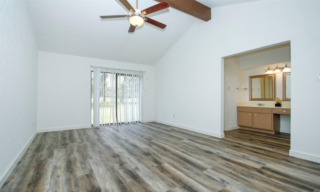 unfurnished bedroom featuring sink, beam ceiling, high vaulted ceiling, ensuite bathroom, and dark hardwood / wood-style flooring