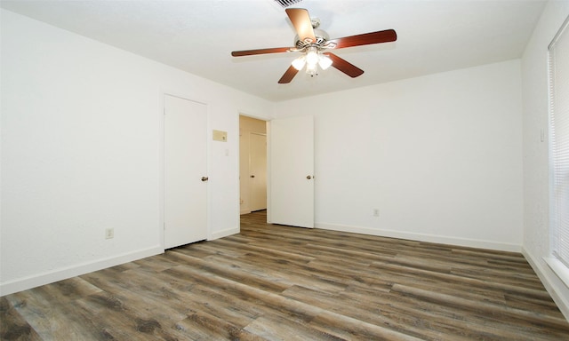 spare room with ceiling fan and dark hardwood / wood-style floors