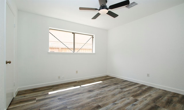 empty room with ceiling fan and dark hardwood / wood-style flooring