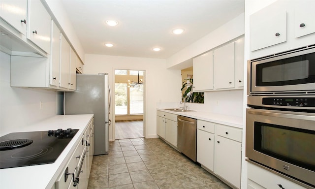 kitchen featuring light tile patterned floors, stainless steel appliances, sink, and white cabinets