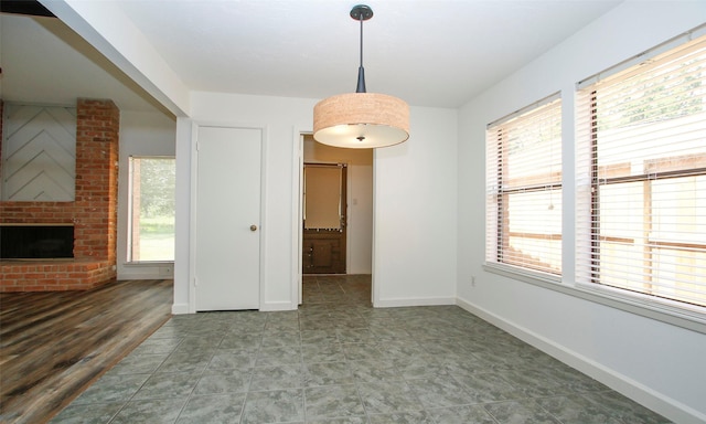 unfurnished dining area with a fireplace