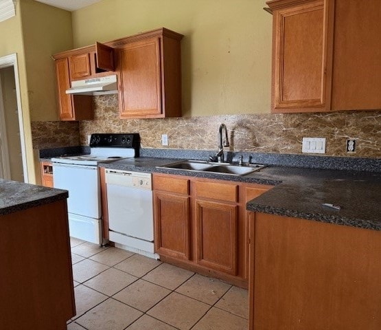 kitchen featuring tasteful backsplash, white appliances, sink, and light tile patterned floors