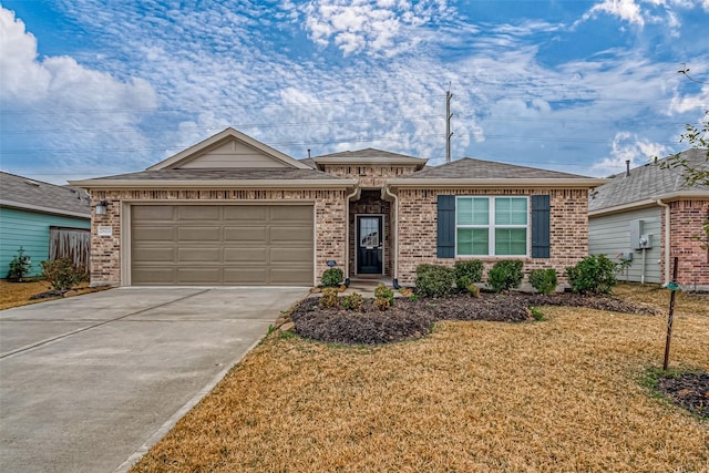 ranch-style home with a garage and a front yard