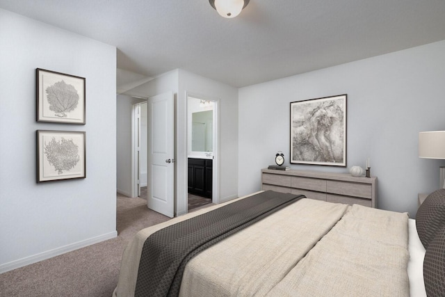 carpeted bedroom featuring ensuite bath