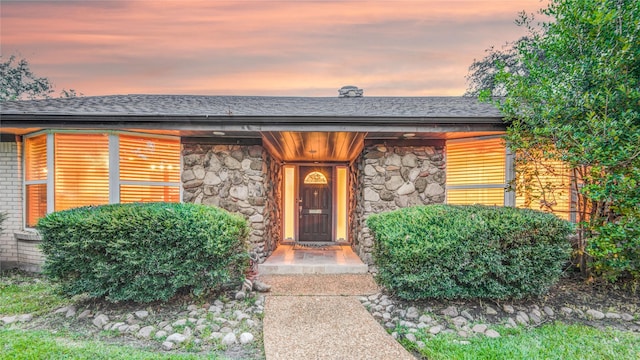 view of exterior entry at dusk