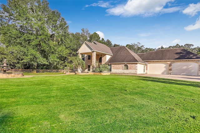 view of front of home with a garage and a front yard