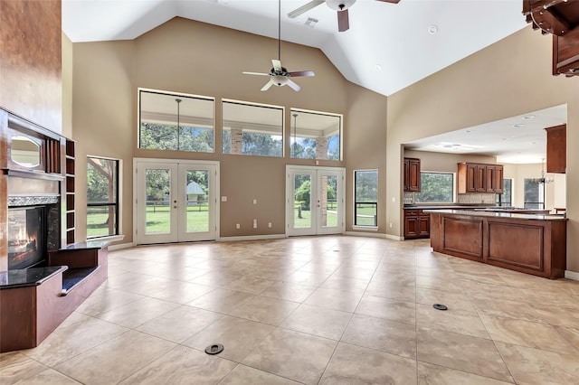 unfurnished living room featuring light tile patterned floors, a premium fireplace, and french doors