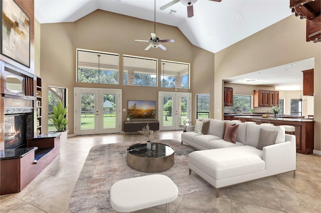 living room with a premium fireplace, high vaulted ceiling, and french doors