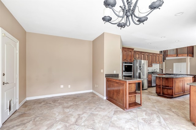 kitchen featuring pendant lighting, stainless steel appliances, a notable chandelier, decorative backsplash, and kitchen peninsula