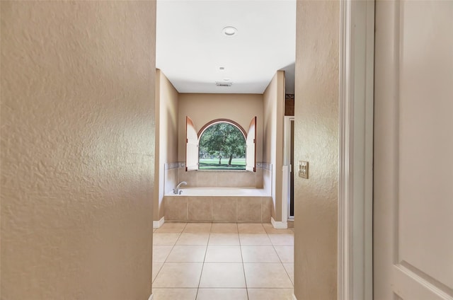 bathroom featuring tile patterned floors and plus walk in shower