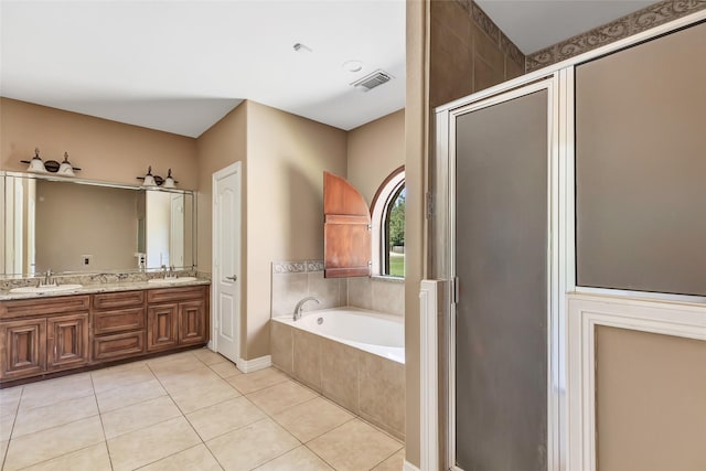 bathroom with plus walk in shower, tile patterned floors, and vanity