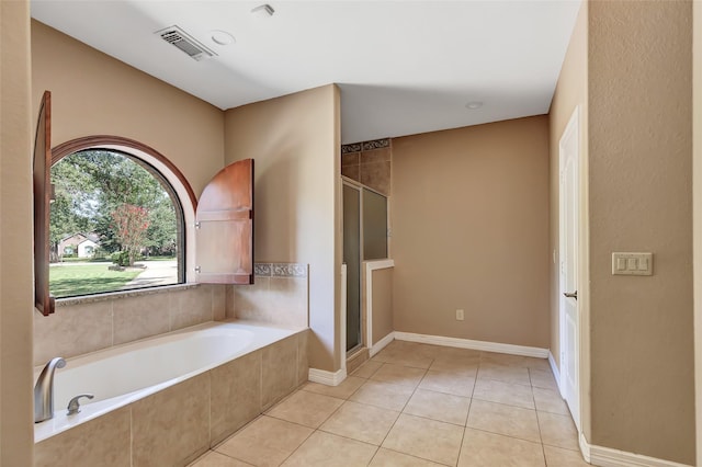 bathroom with tile patterned floors and independent shower and bath