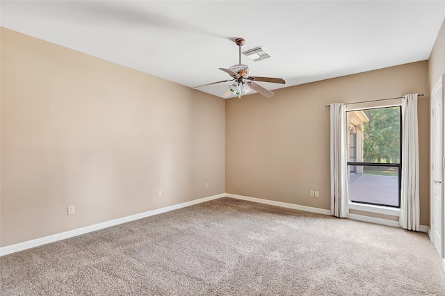 carpeted spare room featuring ceiling fan