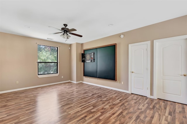 unfurnished room featuring hardwood / wood-style flooring and ceiling fan