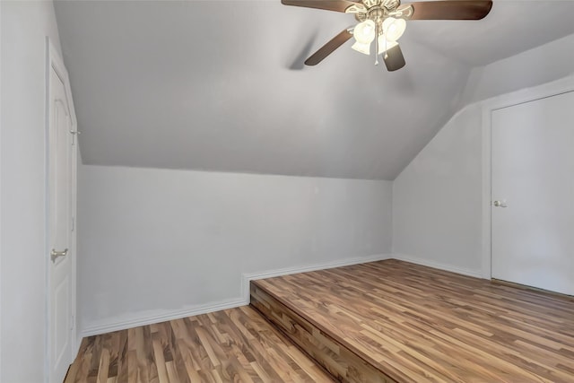 additional living space featuring vaulted ceiling, light hardwood / wood-style floors, and ceiling fan