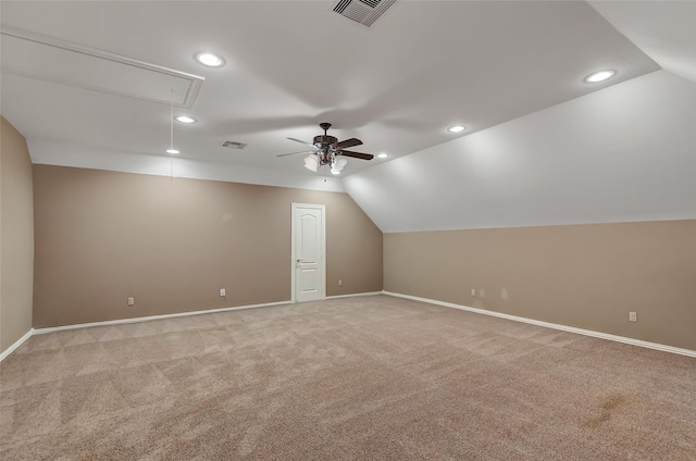 additional living space with ceiling fan, lofted ceiling, and light carpet