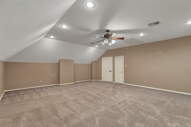 bonus room featuring ceiling fan, lofted ceiling, carpet, and a textured ceiling