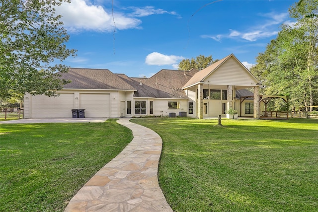 rear view of house featuring a garage and a yard