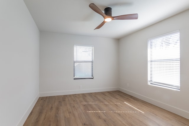 empty room with hardwood / wood-style floors and ceiling fan