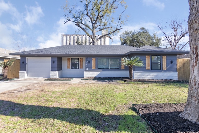 single story home with a garage and a front lawn