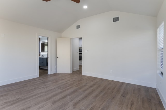 interior space featuring wood-type flooring, lofted ceiling, and ceiling fan