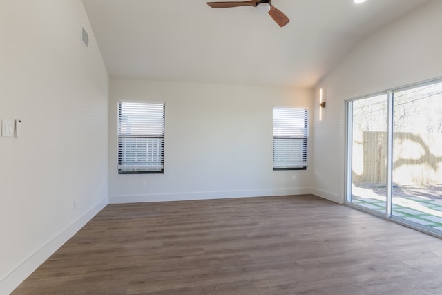 empty room featuring vaulted ceiling, hardwood / wood-style floors, and ceiling fan