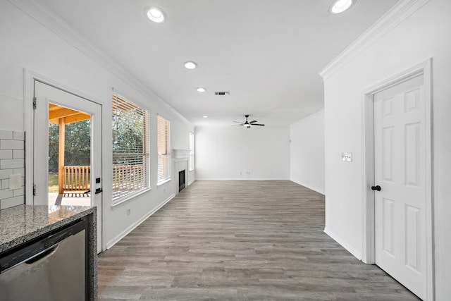 hall with ornamental molding, visible vents, and wood finished floors