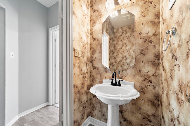 bathroom with wood finished floors and baseboards