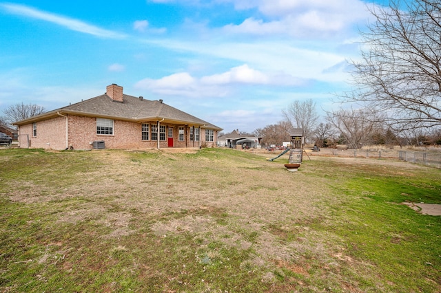 view of yard featuring central AC unit and a playground