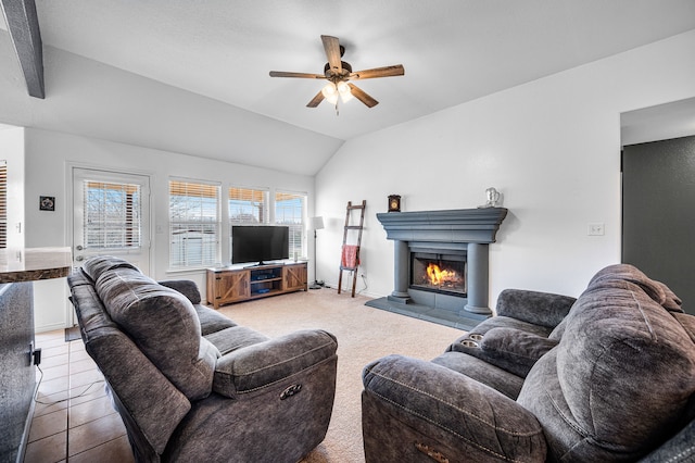 tiled living room featuring lofted ceiling, a tiled fireplace, and ceiling fan