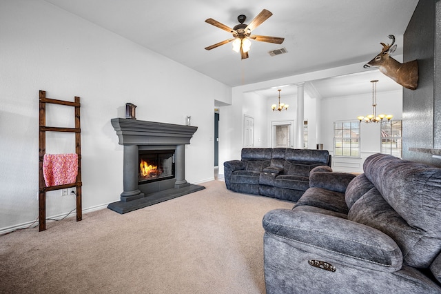 living room featuring carpet flooring and ceiling fan with notable chandelier