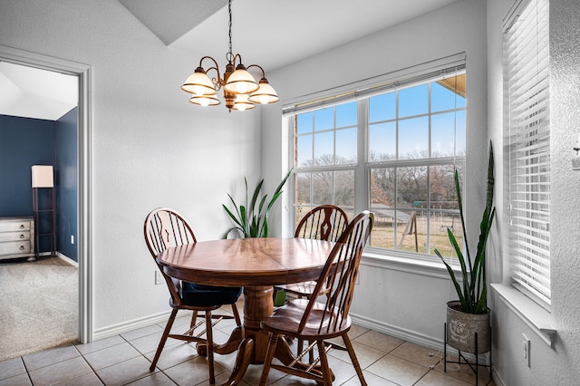 dining space with a notable chandelier and light tile patterned floors