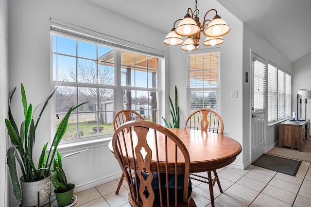 tiled dining space featuring a notable chandelier