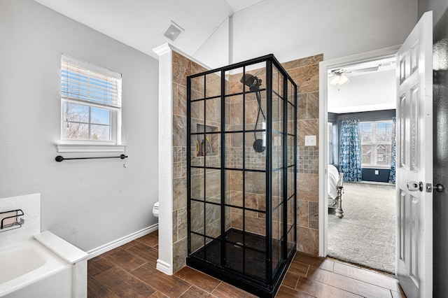 bathroom featuring lofted ceiling, toilet, and separate shower and tub