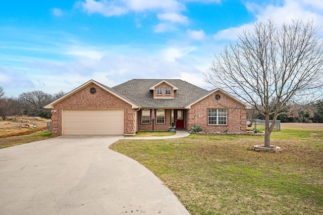 view of front of house with a garage and a front lawn