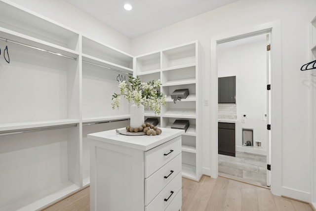 spacious closet with light hardwood / wood-style floors