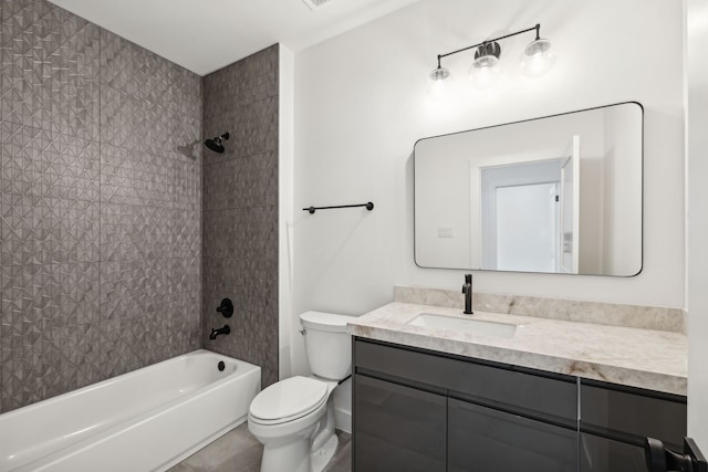 full bathroom with vanity, tiled shower / bath combo, and toilet