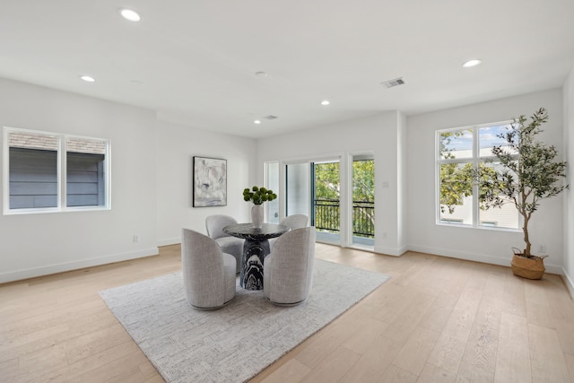 dining area featuring plenty of natural light and light hardwood / wood-style floors