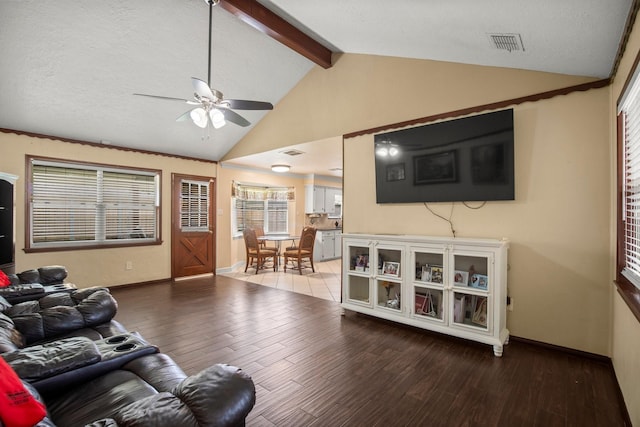 living room featuring hardwood / wood-style floors, a textured ceiling, lofted ceiling with beams, and ceiling fan