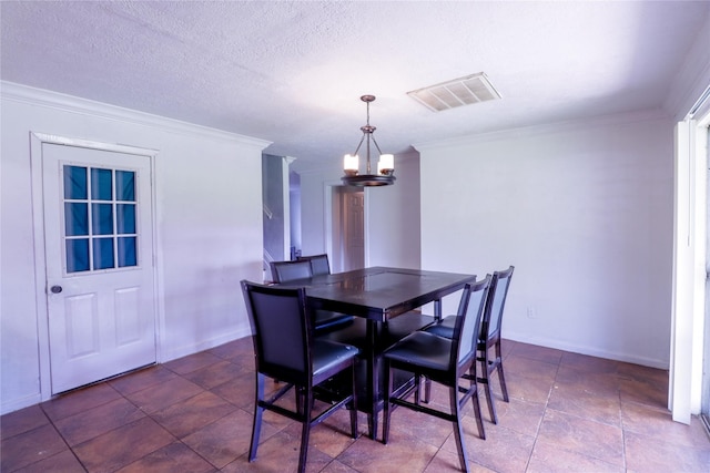 dining area featuring crown molding, a textured ceiling, and a chandelier