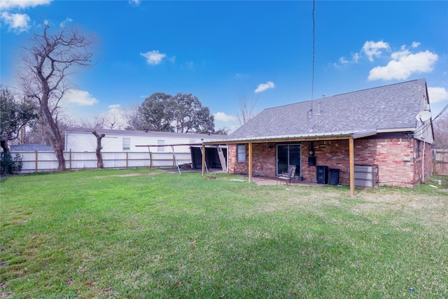 rear view of house with a yard and a patio area