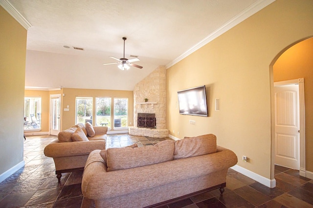 living room featuring ornamental molding, a stone fireplace, lofted ceiling, and ceiling fan