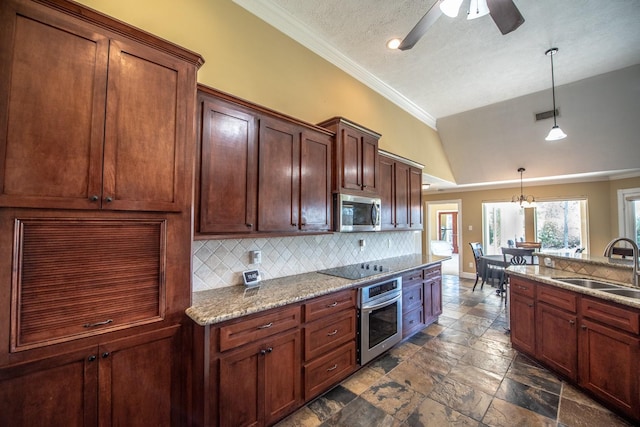 kitchen featuring appliances with stainless steel finishes, decorative light fixtures, tasteful backsplash, sink, and light stone counters